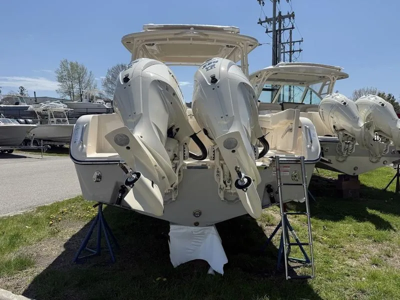 Slide: The Image of 2025 Grady-White Freedom 235 boat with dual outboard engines on display. - 10