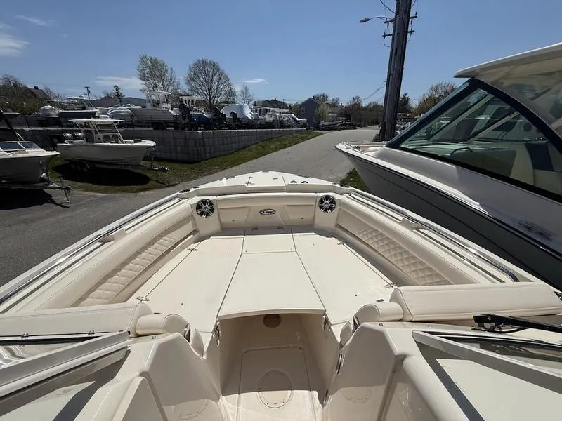 Slide: The Image of 2025 Grady-White Freedom 235 boat, spacious deck, parked outdoors on a sunny day. - 12