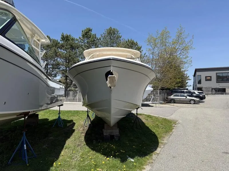 Slide: The Image of 2025 Grady-White Freedom 235 boat on stands, outdoor display, sunny day. - 2