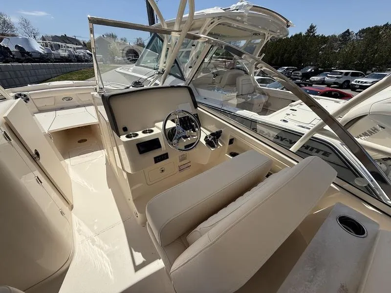 Slide: The Image of 2025 Grady-White Freedom 235 boat interior with steering wheel and seating. - 3