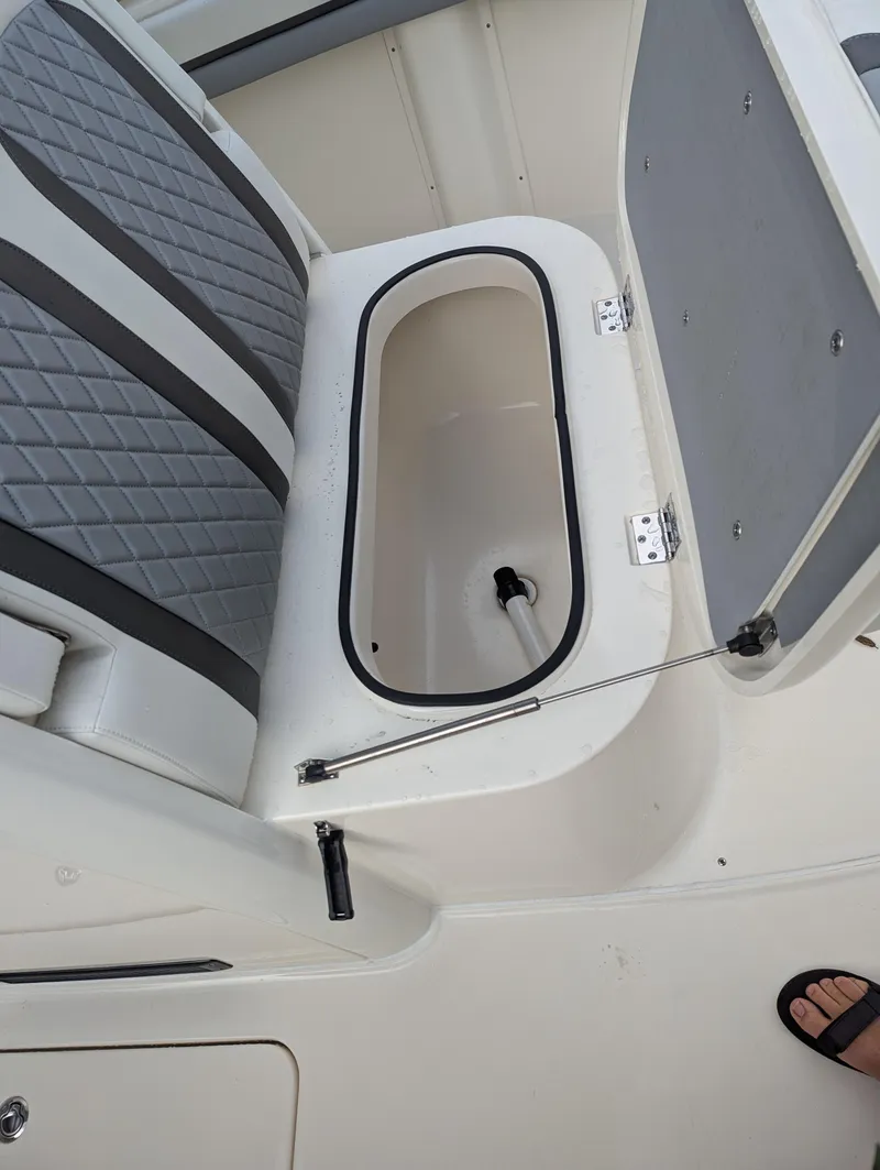 Slide: The Image of 2025 Blackwood 290LXF boat seat with storage compartment open. - 15