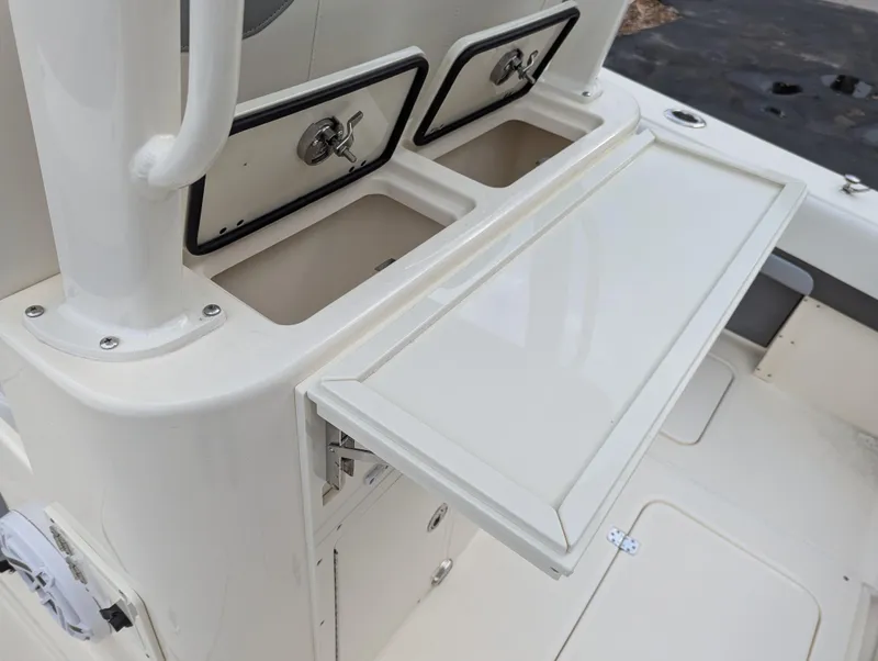 Slide: The Image of 2025 Blackwood 290LXF boat storage compartments and fold-out table. - 18