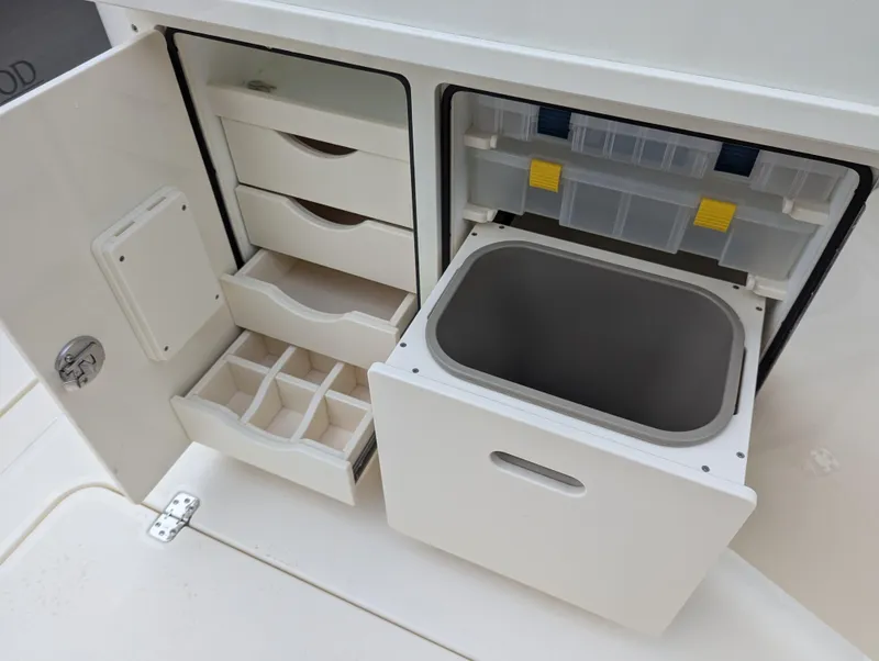 Slide: The Image of 2025 Blackwood 290LXF boat storage compartments with drawers and cooler. - 19