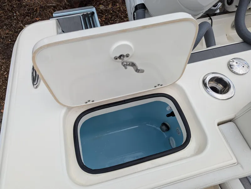 Slide: The Image of 2025 Blackwood 290LXF boat livewell with open lid and sleek design. - 25