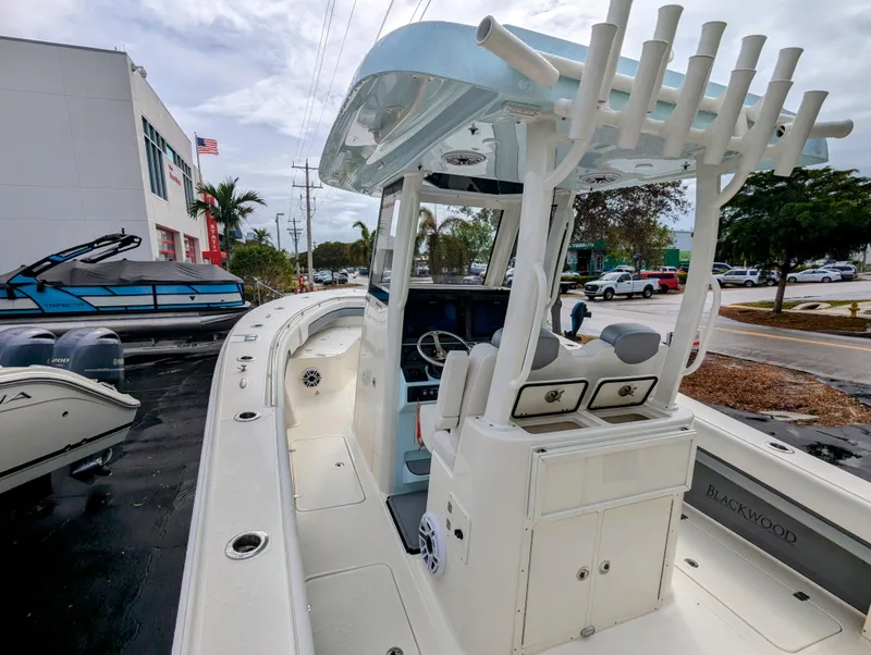 Slide: The Image of 2025 Blackwood 290LXF boat, sleek design, spacious deck, modern features, outdoor showroom. - 27