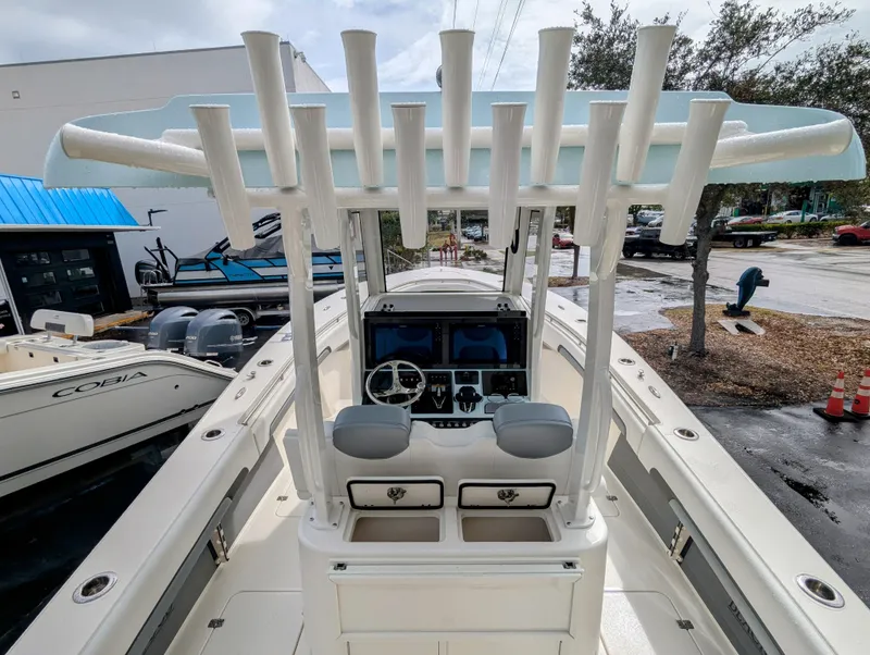 Slide: The Image of 2025 Blackwood 290LXF boat with advanced helm and rod holders, docked outdoors. - 28