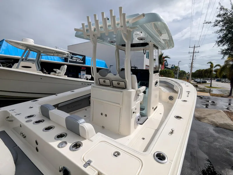 Slide: The Image of 2025 Blackwood 290LXF boat, sleek design, spacious deck, modern features, parked outdoors. - 29