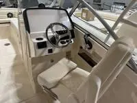 Slide: The Image of 2025 Grady-White Freedom 235 boat interior with steering wheel and seating. - 9