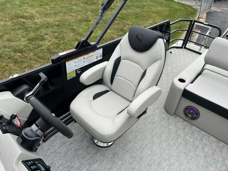Slide: The Image of 2025 South Bay LE 222 UL boat interior with captain's chair and seating area. - 11