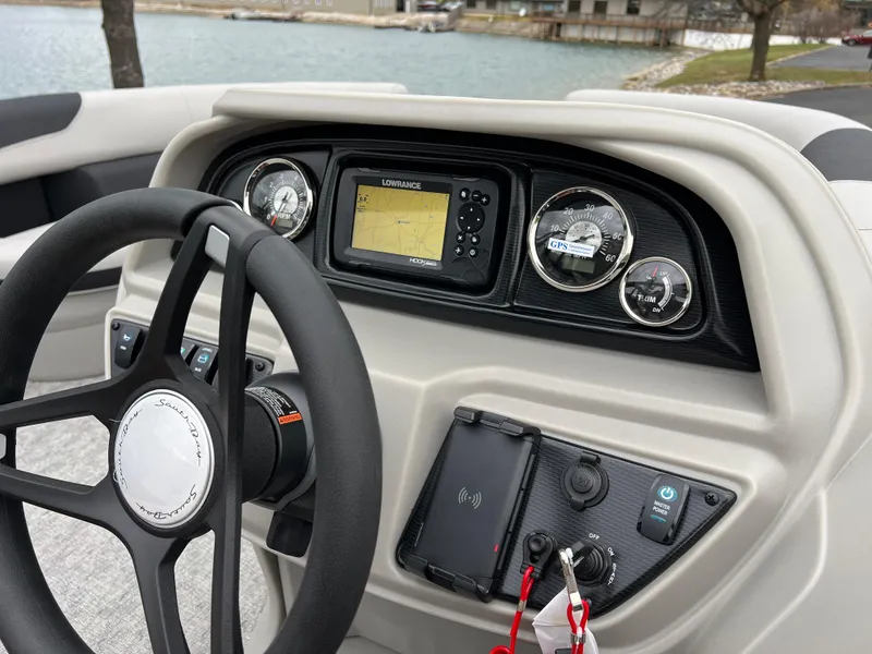 Slide: The Image of 2025 South Bay LE 222 UL boat dashboard with steering wheel and navigation system. - 21