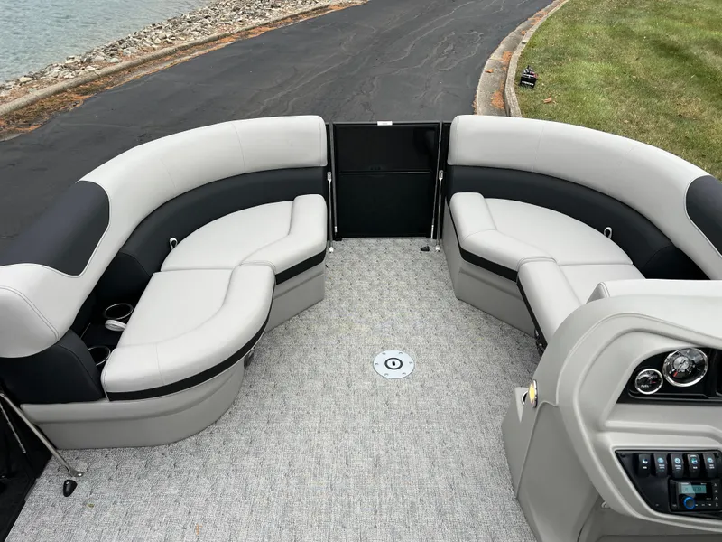 Slide: The Image of 2025 South Bay LE 222 UL pontoon boat interior with plush seating and modern dashboard. - 23
