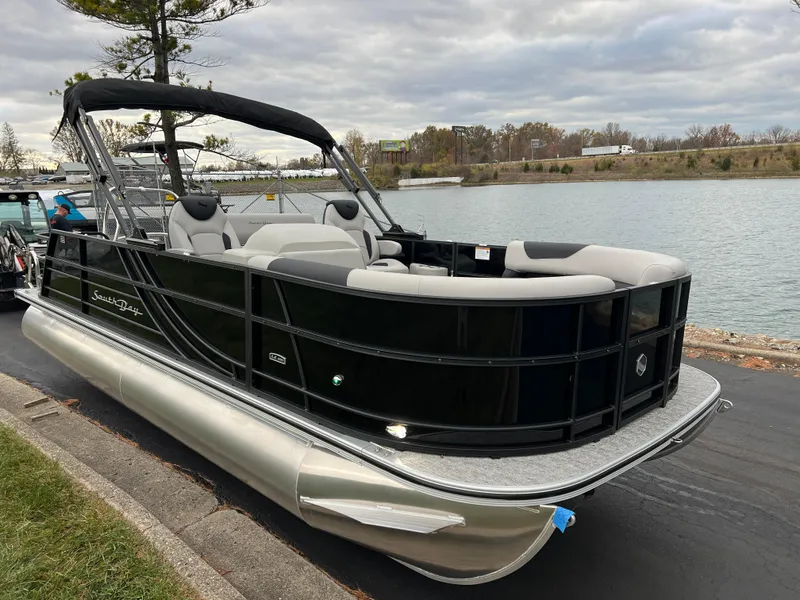 Slide: The Image of 2025 South Bay LE 222 UL pontoon boat docked by a serene lake. - 3
