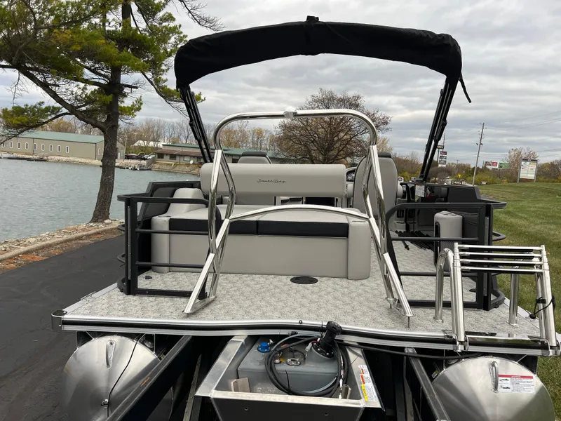 Slide: The Image of 2025 South Bay LE 222 UL pontoon boat docked by a lakeside. - 5