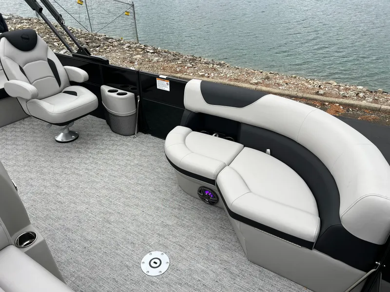 Slide: The Image of 2025 South Bay LE 222 UL pontoon boat interior with plush seating by the water. - 8