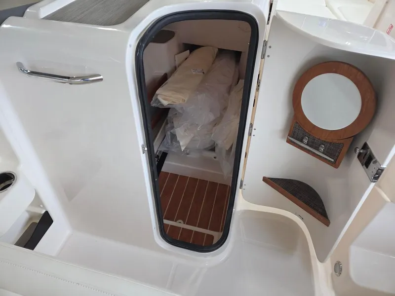 Slide: The Image of 2025 Grady-White Freedom 285 boat cabin interior with storage and mirror. - 14