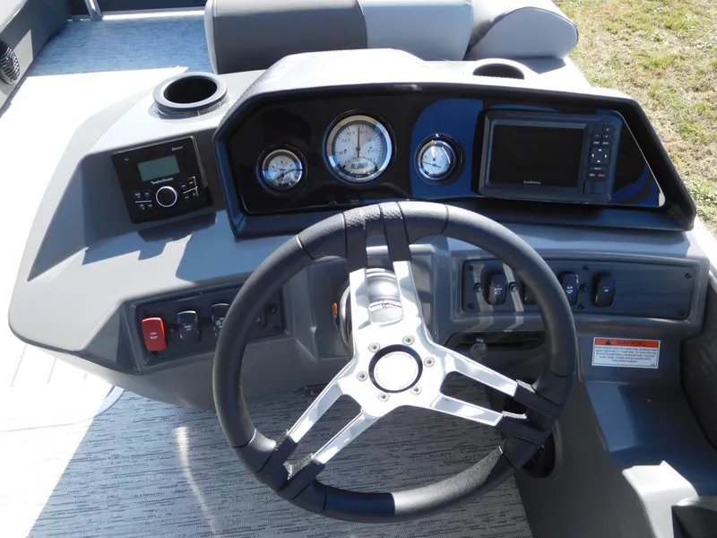 Slide: The Image of 2025 Bennington 23 SS boat dashboard with steering wheel and gauges. - 2