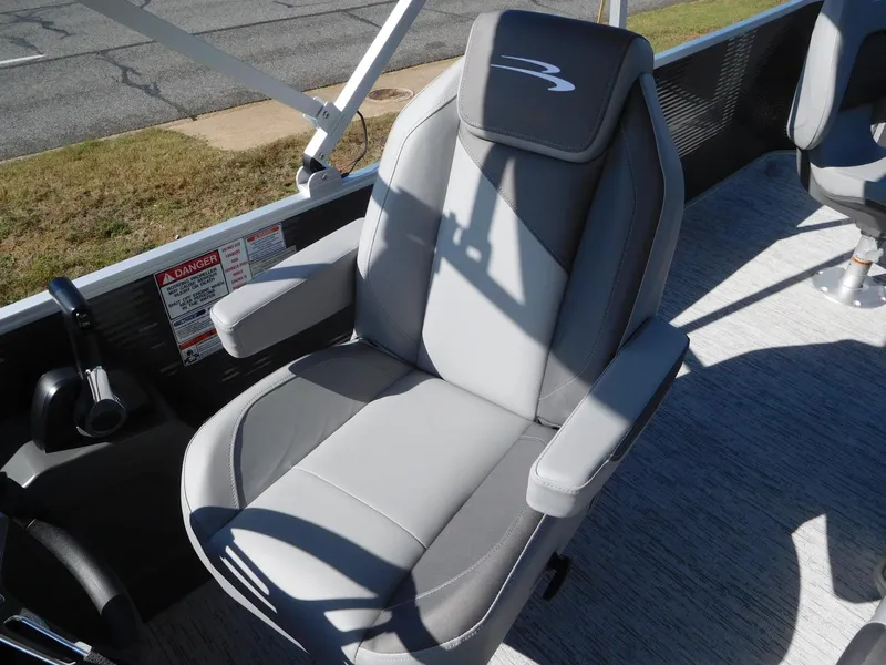 Slide: The Image of 2025 Bennington 23 SS boat seat, gray upholstery, armrests, and logo detail. - 3