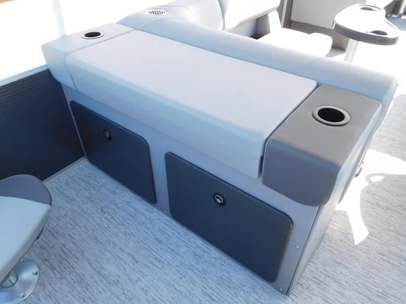 Slide: The Image of 2025 Bennington 23 SS boat seating with storage compartments and cup holders. - 7