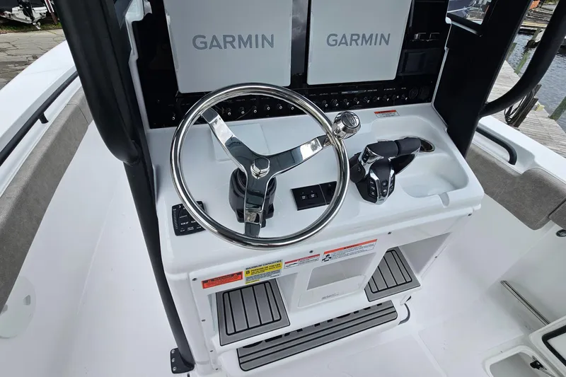 Slide: The Image of 2026 Sea Hunt Gamefish 25 helm with Garmin displays and steering wheel. - 13