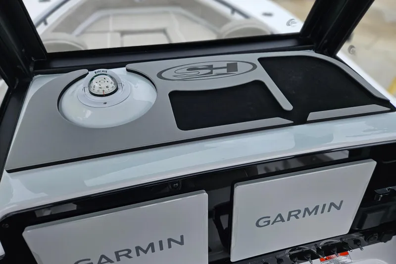 Slide: The Image of 2026 Sea Hunt Gamefish 25 dashboard with Garmin displays and Ritchie compass. - 16