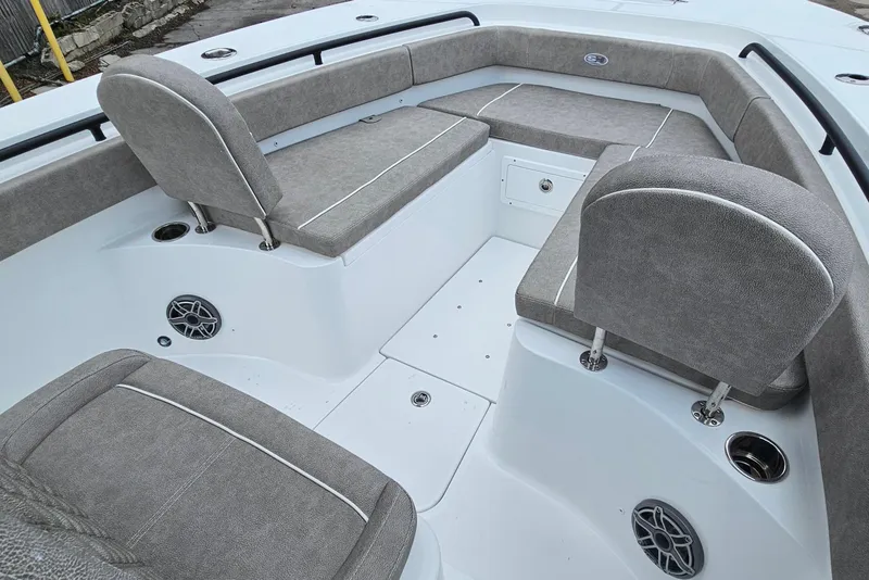 Slide: The Image of 2026 Sea Hunt Gamefish 25 boat interior with gray seating and storage compartments. - 21