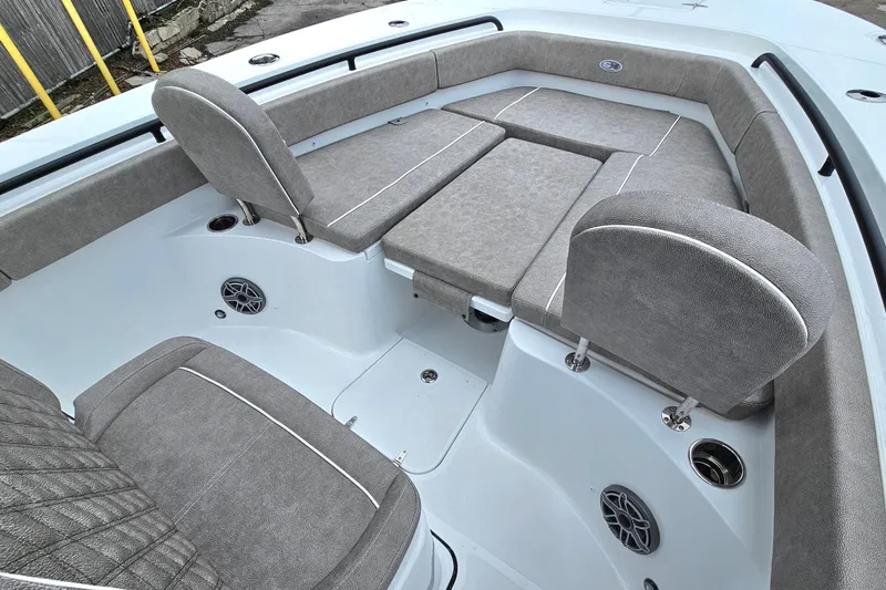 Slide: The Image of 2026 Sea Hunt Gamefish 25 boat interior with cushioned seating and speakers. - 22