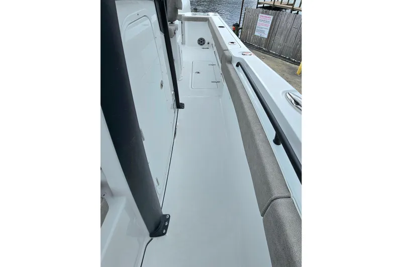 Slide: The Image of 2026 Sea Hunt Gamefish 25 boat interior, featuring sleek design and spacious walkway. - 23