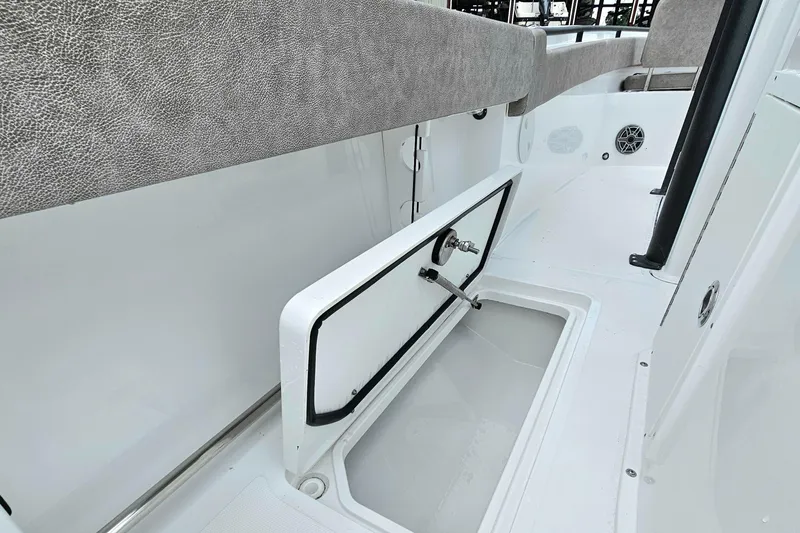 Slide: The Image of 2026 Sea Hunt Gamefish 25 boat interior with open storage compartment. - 25