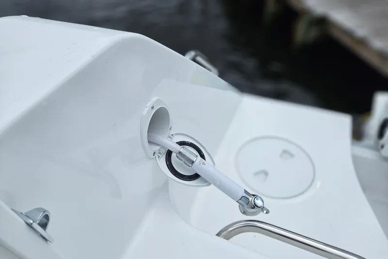 Slide: The Image of 2026 Sea Hunt Gamefish 25 boat detail, featuring a white hose connection. - 29