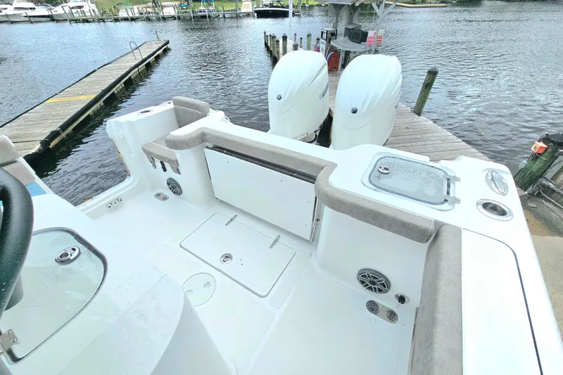 Slide: The Image of 2026 Sea Hunt Gamefish 25 boat interior with dual engines at dockside. - 6
