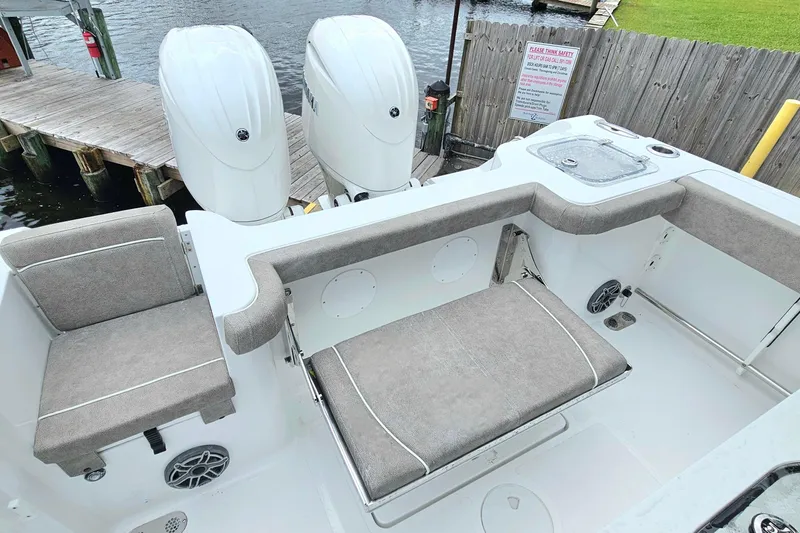 Slide: The Image of 2026 Sea Hunt Gamefish 25 boat interior with dual engines and cushioned seating. - 7