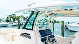 Slide: The Image of 2025 Grady-White Canyon 306 boat at marina, featuring modern helm and sleek design. - 11