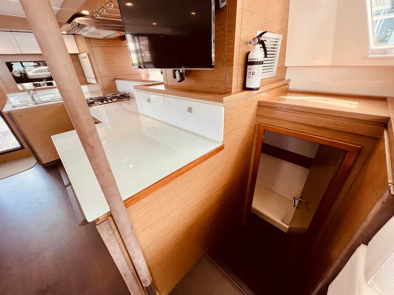Slide: The Image of Interior of 2015 Fountaine Pajot Cumberland 47 LC yacht, featuring modern kitchen and staircase. - 37