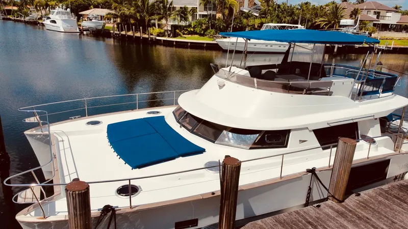 Slide: The Image of 2015 Fountaine Pajot Cumberland 47 LC yacht docked in a serene marina setting. - 6