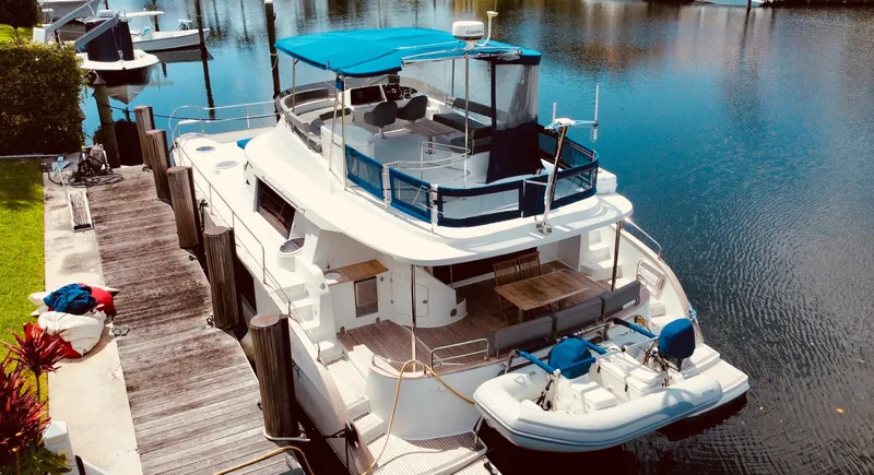Slide: The Image of 2015 Fountaine Pajot Cumberland 47 LC yacht docked by serene waters. - 7
