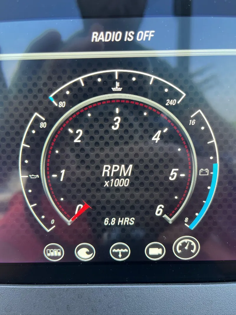 Slide: The Image of 2024 Malibu 20VTX dashboard display showing RPM gauge and radio status. - 14