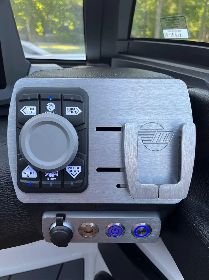 Slide: The Image of 2024 Malibu 20VTX boat control panel with navigation buttons and sleek design. - 18