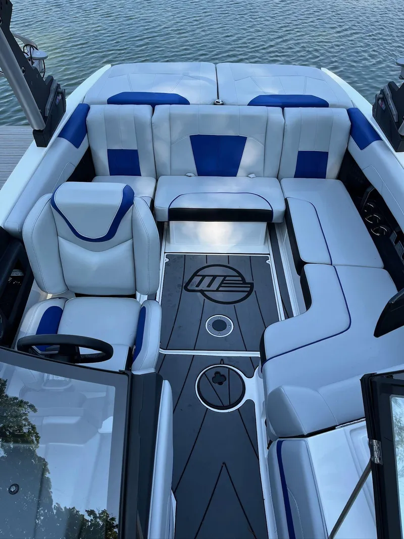 Slide: The Image of 2024 Malibu 20VTX boat interior with blue and white seating, sleek design. - 6