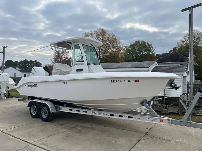 Slide: The Image of 2022 Everglades 235 Center Console boat on trailer, parked outdoors. - 1