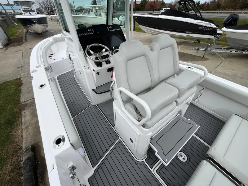 Slide: The Image of 2022 Everglades 235 Center Console boat interior with dual seats and modern dashboard. - 12