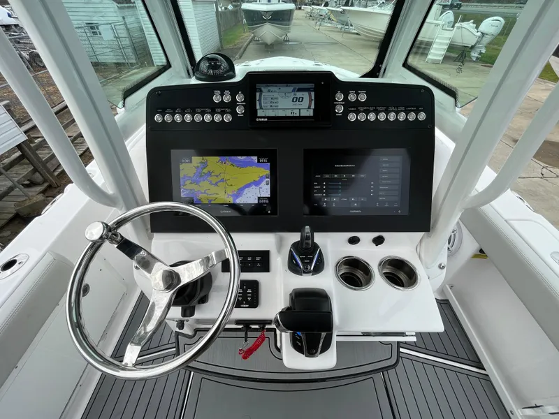 Slide: The Image of 2022 Everglades 235 Center Console boat dashboard with navigation and control systems. - 13
