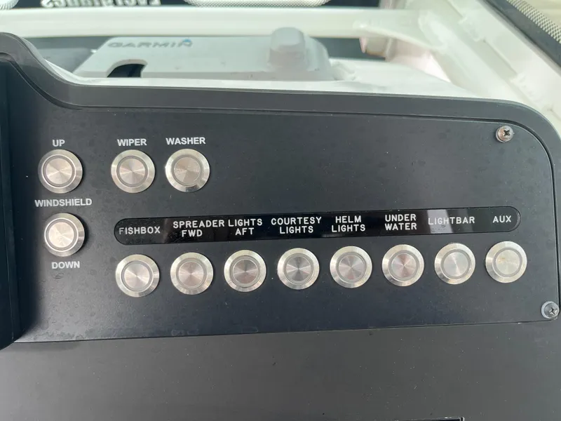 Slide: The Image of Control panel of 2022 Everglades 235 Center Console boat with various switches. - 16
