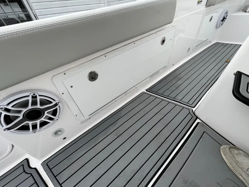 Slide: The Image of 2022 Everglades 235 Center Console boat interior with gray flooring and speaker. - 18