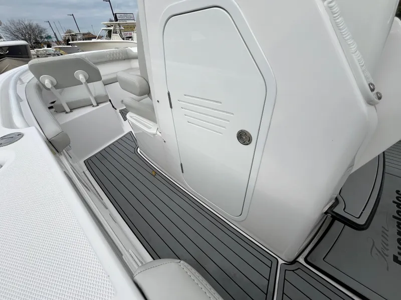 Slide: The Image of 2022 Everglades 235 Center Console boat interior with sleek seating and storage. - 20