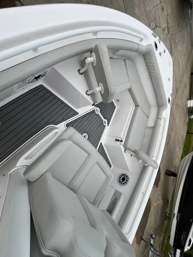 Slide: The Image of 2022 Everglades 235 Center Console boat interior with seating and deck view. - 22