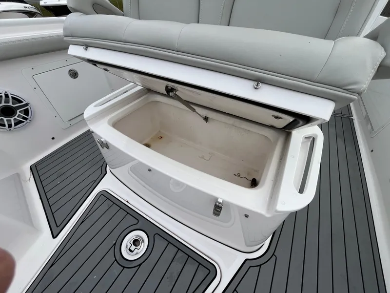 Slide: The Image of Open storage compartment on 2022 Everglades 235 Center Console boat. - 24