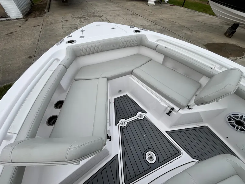 Slide: The Image of 2022 Everglades 235 Center Console boat with cushioned seating and sleek design. - 25
