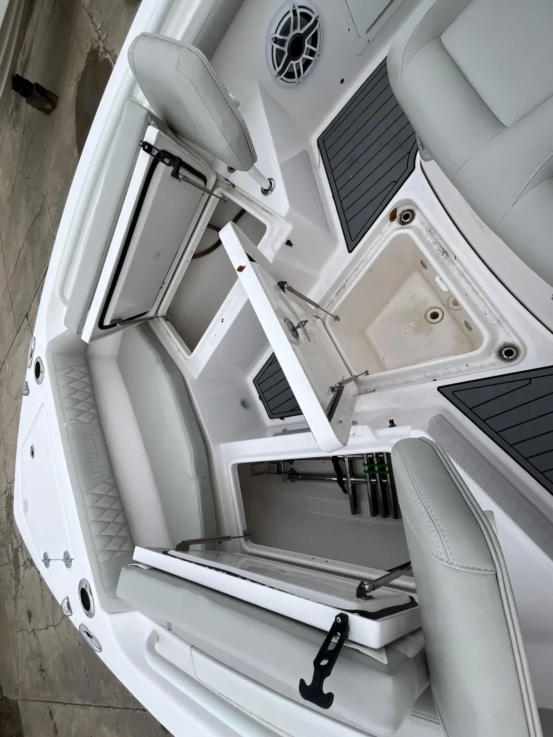 Slide: The Image of 2022 Everglades 235 Center Console boat interior with open storage compartments. - 26