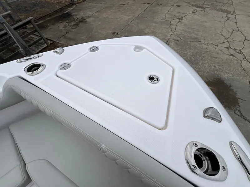 Slide: The Image of 2022 Everglades 235 Center Console boat deck with storage compartment and cup holders. - 27