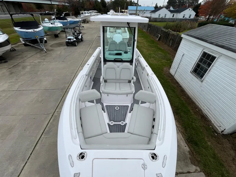 Slide: The Image of 2022 Everglades 235 Center Console boat with spacious seating, docked outdoors. - 29